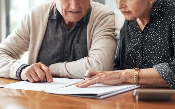 Elderly couple reviewing their trusts Elderly couple reviewing their trusts